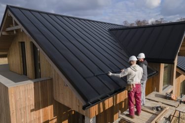 full-shot-roofers-working-together-with-helmets full-shot-roofers-working-together-with-helmets