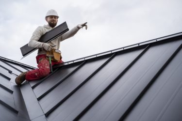 full-shot-smiley-man-working-roof (1)